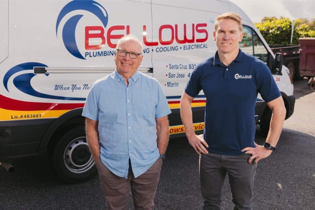 Bellows Plumbing, Heating, Cooling & Electrical team members standing in front of service van.