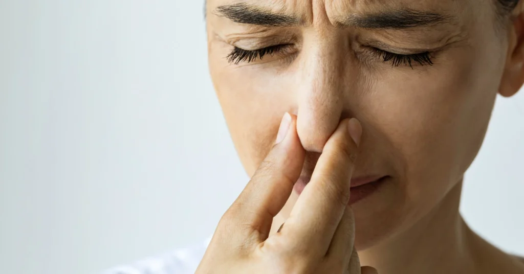 Woman reacting to a strong odor