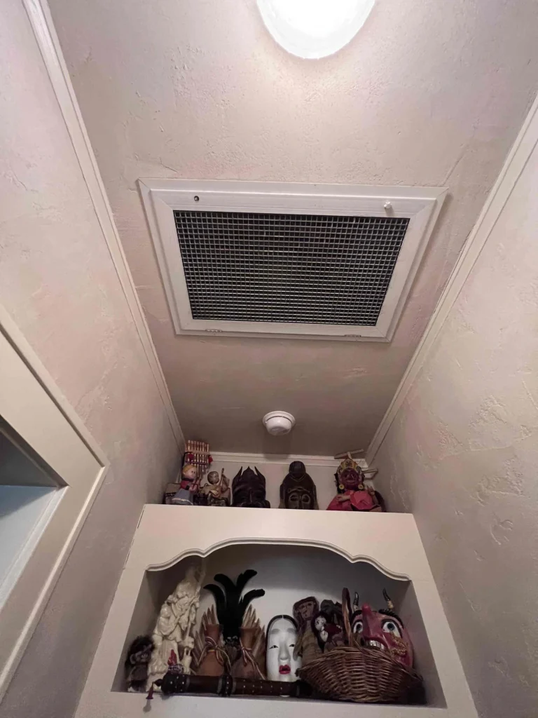 Ceiling-Mounted Return Grille in Hallway