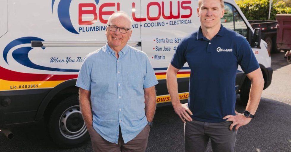 Bellows Plumbing, Heating, Cooling & Electrical team members standing in front of service van.